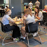 Photo showing students eating at a  table
