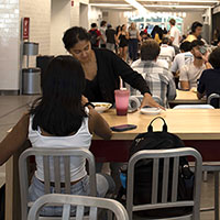 Photo showing two students at a dining table